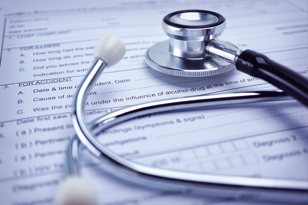 stethoscope on top of insurance papers