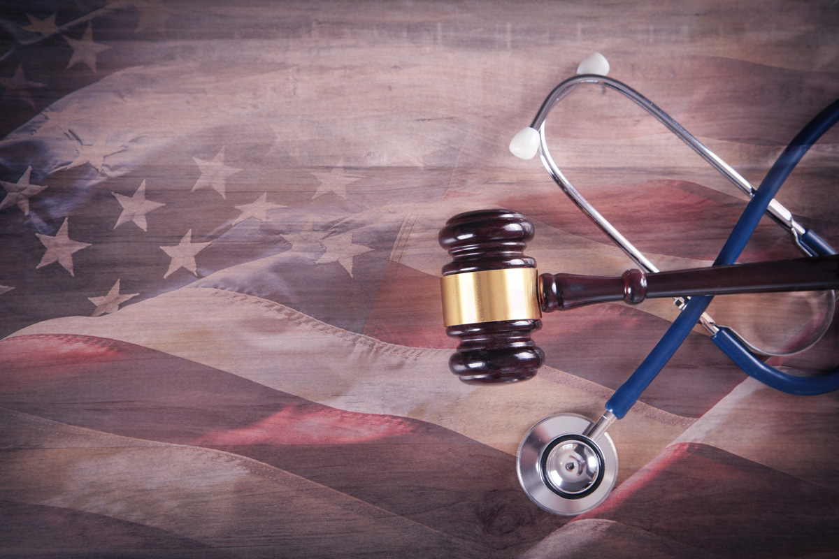 gavel and stethoscope on an American flag