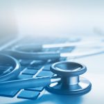 stethoscope on top of a laptop