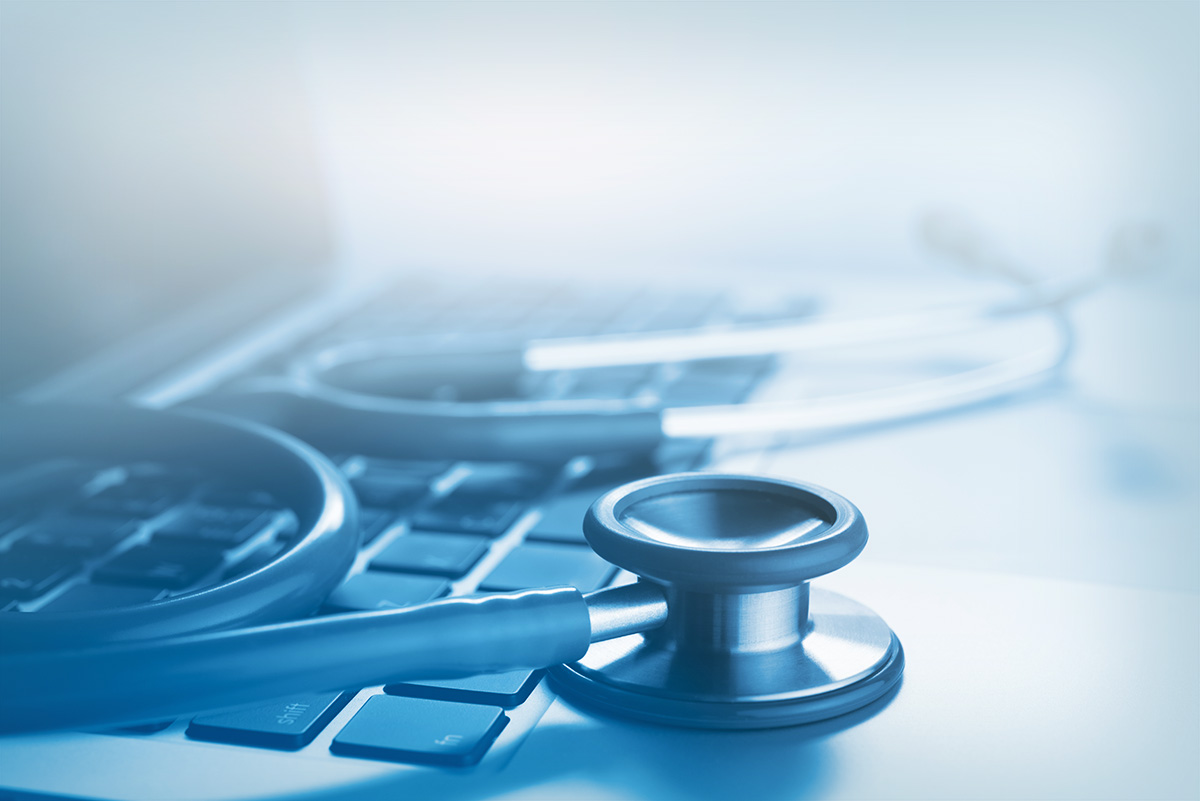 stethoscope on top of a laptop