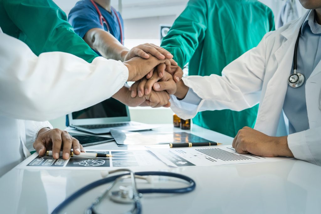 healthcare workers putting hands together