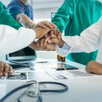 healthcare workers putting hands together
