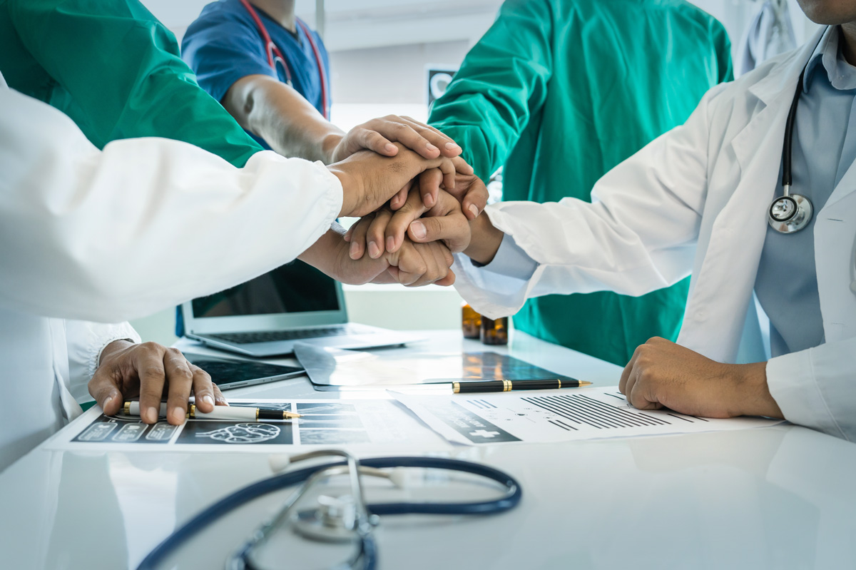healthcare workers putting hands together